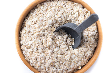 Rolled oats, healthy breakfast cereal oat flakes in bowl isolated on white background. Close up