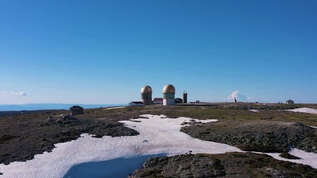 Torre Mountain Peak on Sunny Day. Serra Da Estrela. Highest Point of Continental Portugal. Aerial View. Drone Moves Upwards, Tilt Down