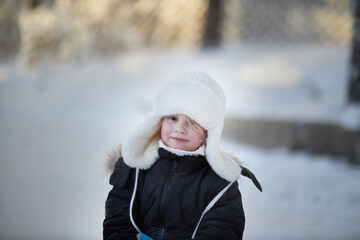 Obraz premium Small Child in Black Jacket and White Hat