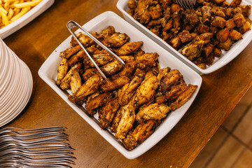 a wooden table topped with white plates and lots of food