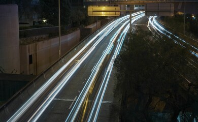 Long exposure shot of cars driving down the highway at night