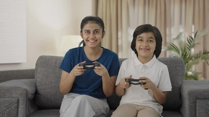 Happy Indian cousins playing video games
