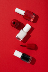 Multicolored nail polishes on a red background