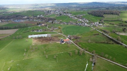 Aerial view of a road in a green rural field