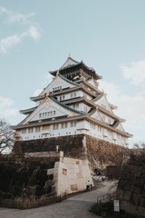 Fototapeta premium Closeup of the historical Osaka Castle Main Tower under the blue sky