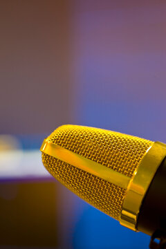 Extreme close up of a gold microphone
