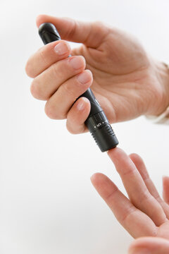 Close up of Woman's Hands Using Glucose Meter
