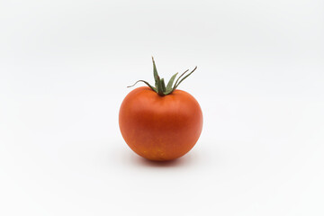 Ripe red tomato on a white background