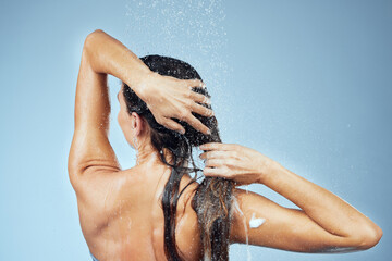 Back, shampoo and woman with hair care for wellness, shower and soap on blue background for...