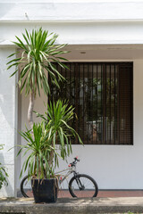 a bicycle parked in front of a window on a house