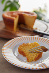 Corn cake being served on a plate with white and orange colors
