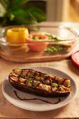 Eggplant stuffed with cheese and barbecue sauce on a gray plate