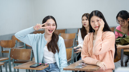 A group of young women are sitting in a classroom