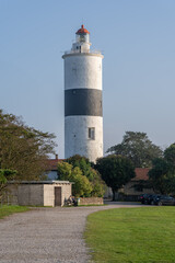 Lighthouse perched above grassy shore