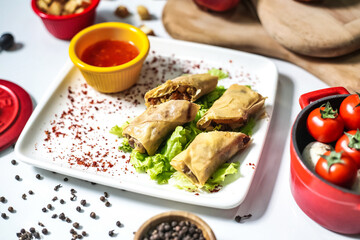 White Plate With Food and Bowl of Sauce