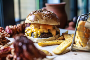 Cheeseburger and French Fries on Wooden Table