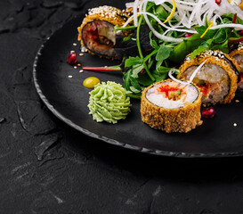 Gourmet sushi roll platter on black slate
