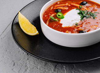 Spicy tomato soup with cream and herbs