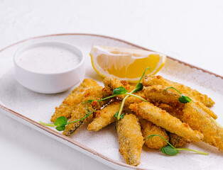 Crispy fried fish fingers with lemon and tartar sauce