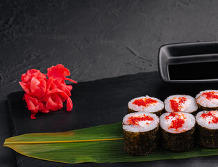 Sushi with red caviar on black stone