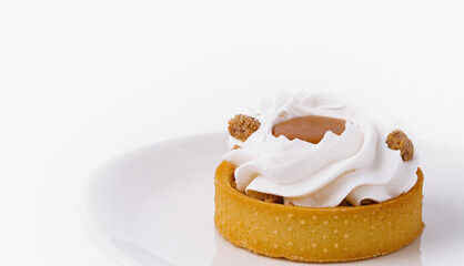 Elegant tartlet with whipped cream on white plate
