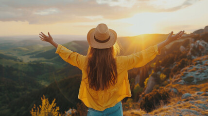 back view of a happy woman with open arms in the sunset on top of mountain, The concept of freedom lifestyle