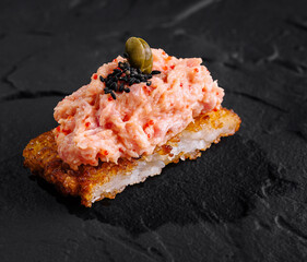 Gourmet salmon tartare on crispy rice cake