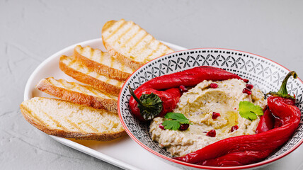 Traditional hummus with roasted peppers and pita bread
