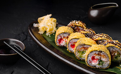 Delectable sushi rolls plated on dark slate background