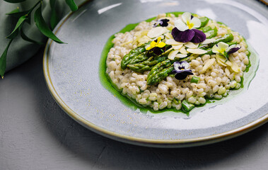 Gourmet risotto with asparagus and edible flowers