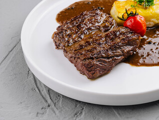 Gourmet grilled steak with potato and sauce