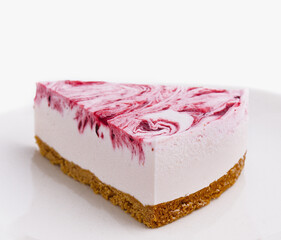 Slice of raspberry cheesecake on white plate
