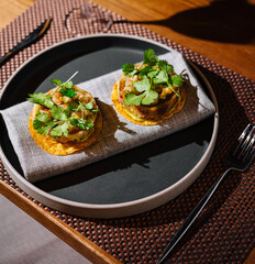 Gourmet toasts with avocado and parsley on elegant plate