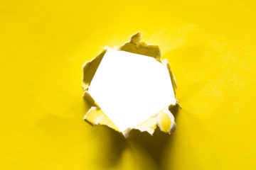 torn hole of yellow paper