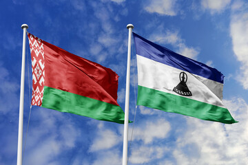 3d illustration. Belarus and Lesotho Flag waving in sky. High detailed waving flag. 3D render. Waving in sky. Flags fluttered in the cloudy sky.