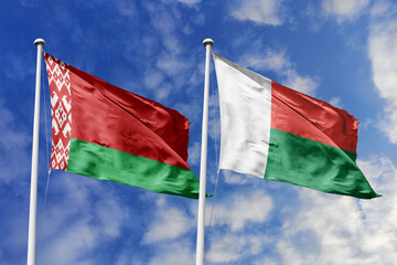 3d illustration. Belarus and Madagascar Flag waving in sky. High detailed waving flag. 3D render. Waving in sky. Flags fluttered in the cloudy sky.