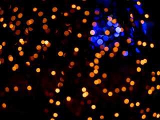abstract blurred bokeh background, bright lights on a black background