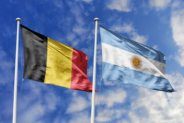 3d illustration. Belgium and Argentina Flag waving in sky. High detailed waving flag. 3D render. Waving in sky. Flags fluttered in the cloudy sky.