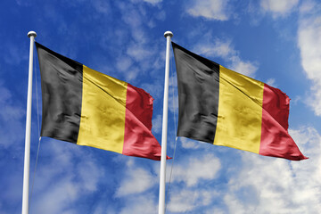 3d illustration. Belgium and Belgium  Flag waving in sky. High detailed waving flag. 3D render. Waving in sky. Flags fluttered in the cloudy sky.