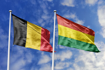 3d illustration. Belgium and Bolivia Flag waving in sky. High detailed waving flag. 3D render. Waving in sky. Flags fluttered in the cloudy sky.