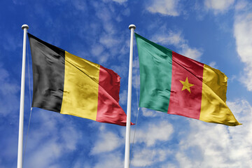 3d illustration. Belgium and Cameroon Flag waving in sky. High detailed waving flag. 3D render. Waving in sky. Flags fluttered in the cloudy sky.
