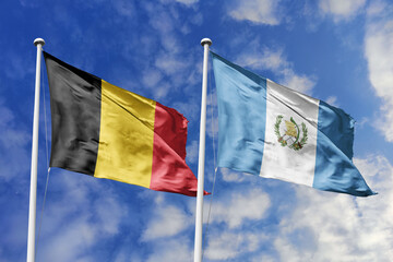 3d illustration. Belgium and Guatemala Flag waving in sky. High detailed waving flag. 3D render. Waving in sky. Flags fluttered in the cloudy sky.
