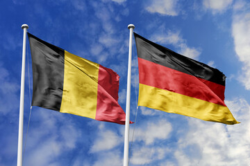 3d illustration. Belgium and Germany Flag waving in sky. High detailed waving flag. 3D render. Waving in sky. Flags fluttered in the cloudy sky.