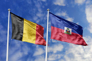 3d illustration. Belgium and Haiti Flag waving in sky. High detailed waving flag. 3D render. Waving in sky. Flags fluttered in the cloudy sky.
