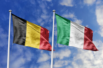 3d illustration. Belgium and Italy Flag waving in sky. High detailed waving flag. 3D render. Waving in sky. Flags fluttered in the cloudy sky.