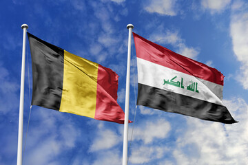3d illustration. Belgium and Iraq Flag waving in sky. High detailed waving flag. 3D render. Waving in sky. Flags fluttered in the cloudy sky.
