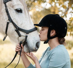 Equestrian, horse riding and woman jockey kissing animal outdoor on farm for bonding or training....