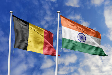 3d illustration. Belgium and India Flag waving in sky. High detailed waving flag. 3D render. Waving in sky. Flags fluttered in the cloudy sky.