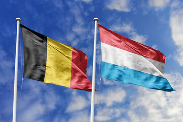 3d illustration. Belgium and Luxembourg Flag waving in sky. High detailed waving flag. 3D render. Waving in sky. Flags fluttered in the cloudy sky.