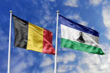 3d illustration. Belgium and Lesotho Flag waving in sky. High detailed waving flag. 3D render. Waving in sky. Flags fluttered in the cloudy sky.